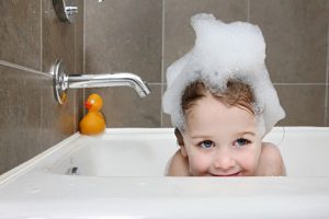 Girl taking bubble bath.