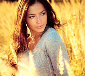 young brunette woman  portrait at sunny yellow autumn field